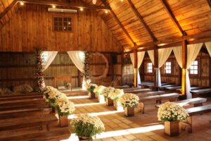 Intimate wedding venue with wooden pews and golden sunlight coming through the windows